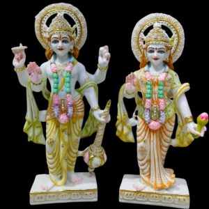 🌟 Exquisite Marble Vishnu and Lakshmi Murti Set by Gatimaan Creation 🌟 Bring divine grace and prosperity into your home with this stunning pair of Hindu deities, Lord Vishnu and Goddess Lakshmi, meticulously crafted by Gatimaan Creation. ✨ Product Highlights Material: Premium quality Stone/Marble, giving the statues a smooth, luminous white finish with delicate veining. Craftsmanship: Expertly hand-painted with vibrant, yet subtle colors in shades of yellow, green, pink, and orange, accented with intricate gold detailing and sparkling embellishments. Deities: Lord Vishnu: Depicted in a standing posture, holding his traditional attributes, the Conch (Shankha) and a Mace (Gada). His upper right hand is raised in a gesture of blessing (Abhaya Mudra). Goddess Lakshmi: Standing beside her consort, holding a Lotus (Kamala) in her hand, signifying purity and beauty. Her left hand is raised in a gesture of fearlessness and assurance. Aura & Detail: Both statues feature beautifully carved Kiritamukuta (crowns) and circular Halos behind their heads, highlighting their divine presence. They are adorned with colorful garlands and necklaces. Base: Each statue stands firmly on a square, white base with elegant gold trim. Dimensions: Perfect for placement in your home temple (Mandir), altar, or as a magnificent centerpiece for your living space. 💖 Why Choose This Set? This magnificent Vishnu-Lakshmi Murti Set is more than just a decorative piece; it is a symbol of harmony, wealth, good fortune, and cosmic balance. Lord Vishnu is the preserver of the universe, and Goddess Lakshmi is the giver of spiritual and material prosperity. Ideal for: Pooja ceremonies, housewarming gifts (Griha Pravesh), weddings, festivals (Diwali, Janmashtami), or as an exceptional collector's item. Artist: Proudly made by Gatimaan Creation, a name synonymous with fine, high-quality spiritual artistry.